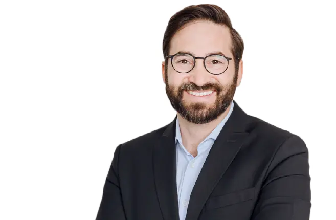 Bild des Ansprechpartners für TSR40; Mann mit freundlichem Gesichtsausdruck und Vollbart, Brille, Hemd und Sakko