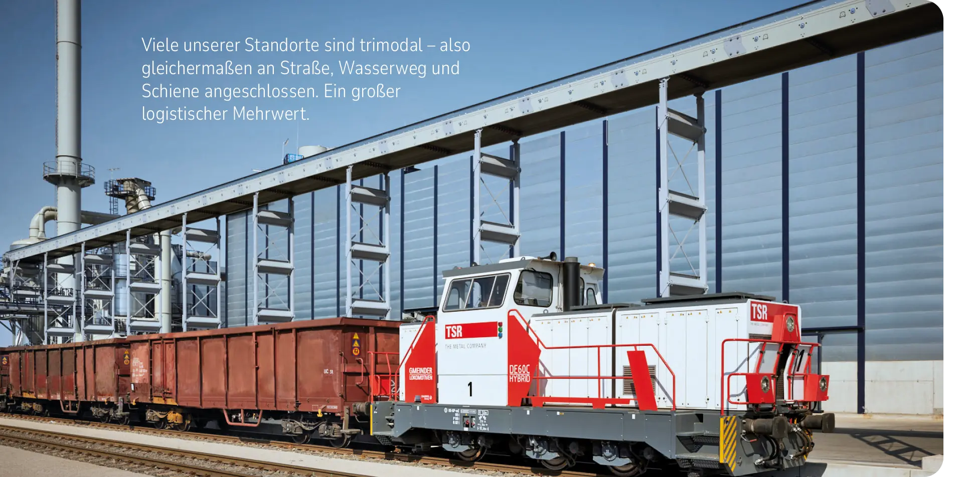 eine Lok mit Anhängern vor der Recyclinganlage in Duisburg